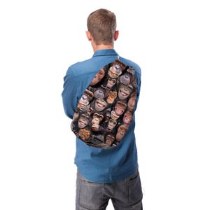 May include: A backpack featuring a collage of smiling chimpanzee faces in various shades of brown and tan. The backpack is worn over the shoulder, with a white drawstring closure. The background is white.