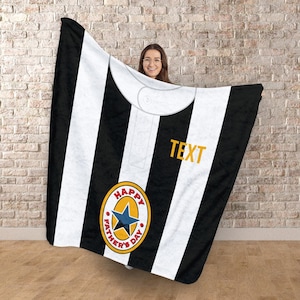 May include: Black and white striped blanket with a collar design. Features a yellow and blue emblem that says "HAPPY FATHER'S DAY" and the word "TEXT" in yellow.