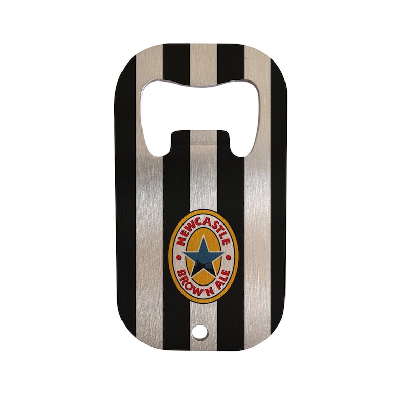 May include: Bottle opener with a black and white striped design. The opener features the Newcastle Brown Ale logo in the center. The opener has a hole at the bottom for easy storage.