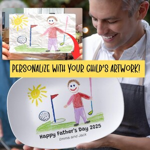 May include: A white, oval-shaped plate featuring a child's drawing of a golfer, a golf ball, and a sun. The plate is personalized with the text "Happy Father's Day 2025" and the names "Emma and Jack". The text "PERSONALIZE WITH YOUR CHILD'S ARTWORK!" is also present.