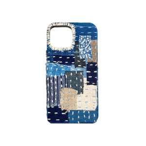 May include: A blue and white patchwork phone case with a variety of textures and stitching. The case is made of fabric and has a cutout for the camera lens.