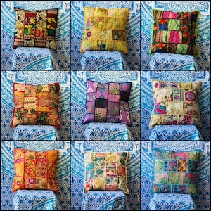 May include: Nine colourful patchwork cushion covers with embroidered details. The cushions are arranged in three rows of three on a blue and white patterned background.