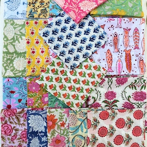 May include: A collection of 20 colorful fabric squares with various floral and geometric patterns. The squares are arranged in a grid pattern and are all folded in half.