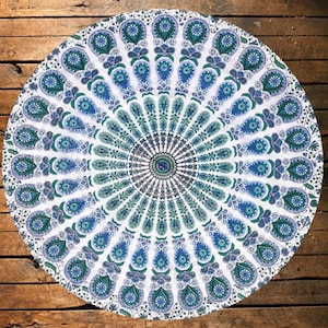 May include: A white round tapestry with a blue and green mandala design. The mandala features a repeating pattern of paisley shapes.