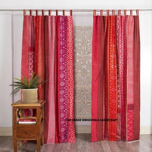 May include: Red and white striped curtains with a geometric pattern. The curtains are made of cotton and are hung on a metal rod.