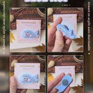 May include: Blue koi fish magnet from the Koi / Totoro Collection. The magnet is light blue with red and white details. The text "BLUE KOI" and "HANDMADE Magnet" are visible. The artist's name, "Art by Asudraws", is also displayed.