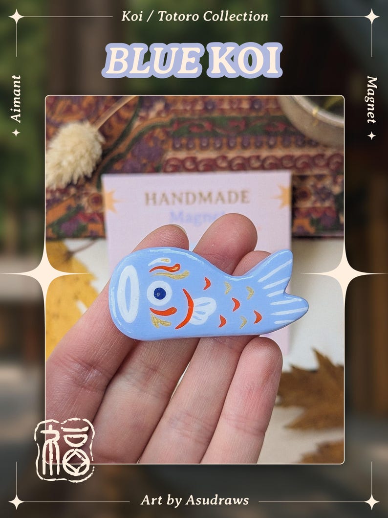 May include: A light blue koi fish magnet with orange and white details. The magnet is part of the "Blue Koi" collection and is handmade. The image also includes the text "Aimant" and "Magnet".