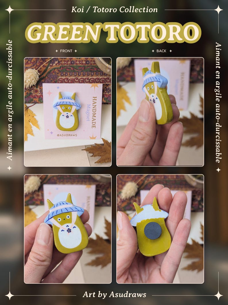 May include: A handmade green Totoro magnet from the Koi / Totoro Collection. The magnet features a yellow Totoro character with a blue hat and white belly. The text "GREEN TOTORO" is displayed above the magnet. The text "Art by Asudraws" is displayed below the magnet.