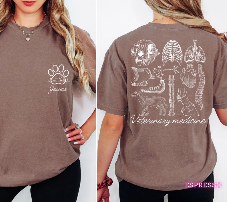 May include: A brown t-shirt with a white paw print and heartbeat graphic on the left side and the name "Jessica" underneath. The back of the shirt has a white graphic of various animal anatomy illustrations and the text "Veterinary medicine".