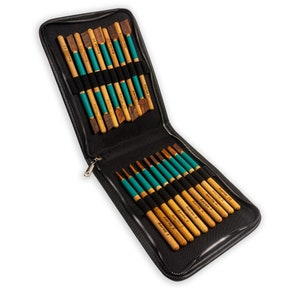 May include: A black leather case with a zipper closure, open to reveal a set of 18 wooden tools with green and black accents. The tools are labeled with numbers 1 through 18.