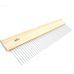 May include: A wooden comb with a long, thin handle and a row of metal teeth. The comb is labeled "karin".
