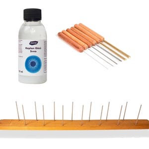 Könnte beinhalten: Eine durchsichtige Kunststoffflasche mit schwarzem Verschluss und der Aufschrift Karin Kaplan Gözü Sivisi 100 ml, ein Set aus sechs Metallwerkzeugen mit Holzgriffen und ein langer rechteckiger Holzblock mit fünfzehn dünnen Metallstäben.
