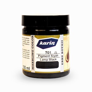 May include: A 105 ml jar of black marbling color paint labeled "karin 701 Pigment Siyah Lamp Black" in English and Turkish. The jar has a black lid and a gold label with blue lettering.