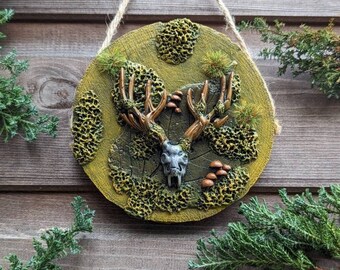 Wall hanging deer skull on a slice of wood,handmade in polymer clay,forest scene