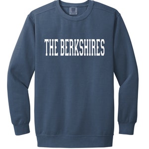 May include: A blue sweatshirt with the text "THE BERKSHIRES" printed in white on the front.