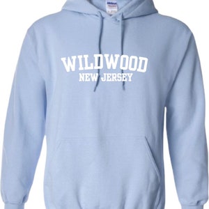 May include: Light blue hooded sweatshirt with white text that reads "WILDWOOD NEW JERSEY".