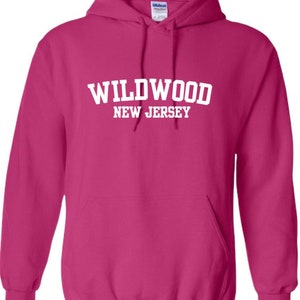 May include: A pink hooded sweatshirt with the text "WILDWOOD NEW JERSEY" in white.