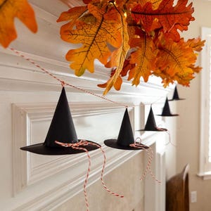 Witch hat printable template, Halloween DIY paper hat, witch party craft idea, printable Halloween banner, witch hat decoration for mantel, spooky witch hat garland, cute Halloween paper craft, witch hat DIY decor, Halloween witchy printable, festive witch hat artwork