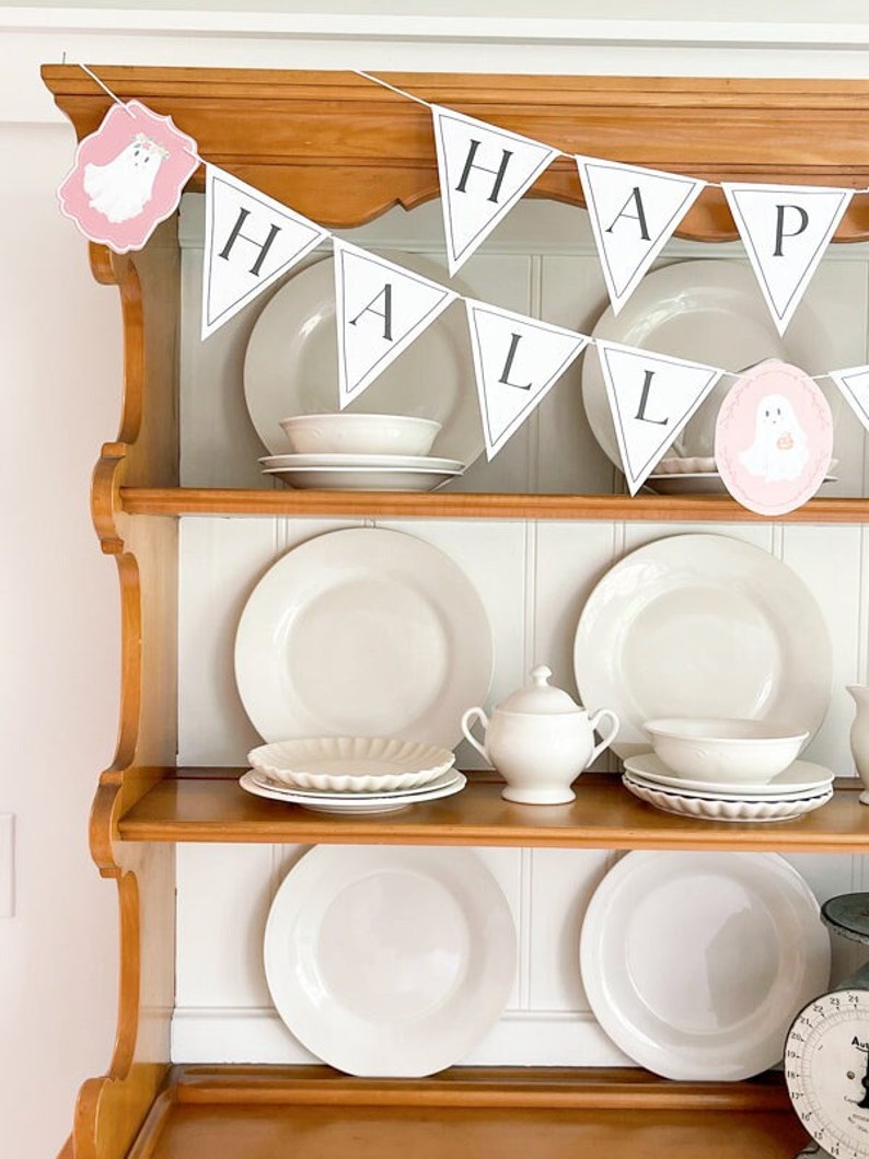 Pink pastel Halloween ghost paper decoration printable made into a Happy Halloween letter garland with ghosts
