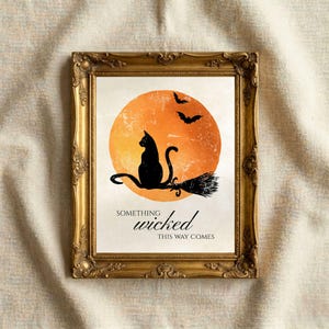 Black cat Halloween quote print in an ornate gold vintage frame on a linen background