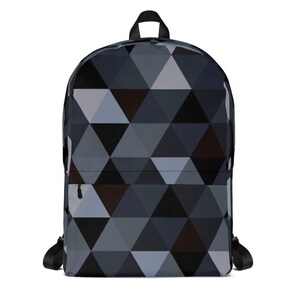 Puede incluir: Una mochila negra con un patrón geométrico de triángulos grises y azules.