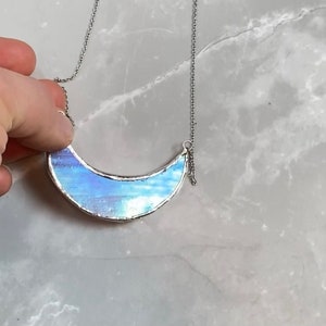 Stained glass crescent moon necklace with lead free solder. May the power of your moon goddess flow through its purple iridescent glow