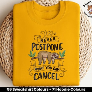 May include: Yellow sweatshirt with a sloth graphic and the text "Never Postpone What You Can Cancel".