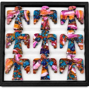 May include: Nine flat, bird-shaped stone carvings arranged in a three-by-three grid. Each piece features a mosaic pattern of vibrant pink, orange, and blue stone fragments held together by copper-coloured veins, creating a distinct avian silhouette.