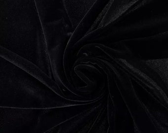 May include: Black velvet fabric with a soft, smooth texture. The fabric is draped and folded, creating a luxurious and elegant look.