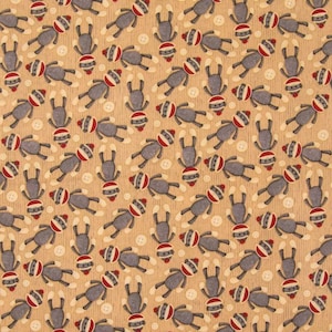 May include: A beige fabric with a repeating pattern of gray sock monkeys. The monkeys are wearing red and white striped hats and have black eyes and mouths.