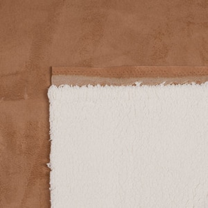 May include: A brown faux suede throw blanket with a white sherpa lining.