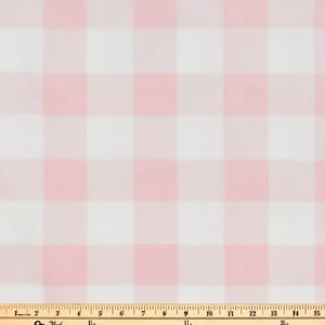 May include: Pink and white gingham fabric with a ruler for scale.
