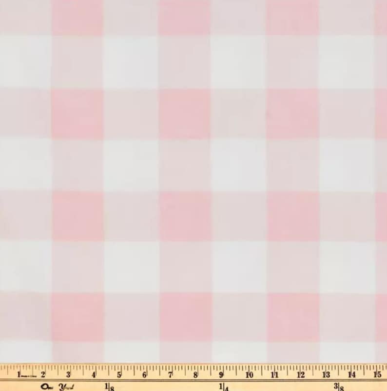 May include: Pink and white gingham fabric with a ruler for scale.