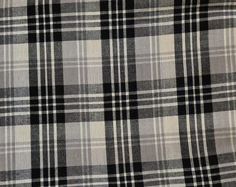 May include: A woven fabric featuring a classic plaid pattern in shades of black, white, and various tones of gray. The design consists of intersecting horizontal and vertical lines of varying widths, creating a repeating grid of solid and striped squares.