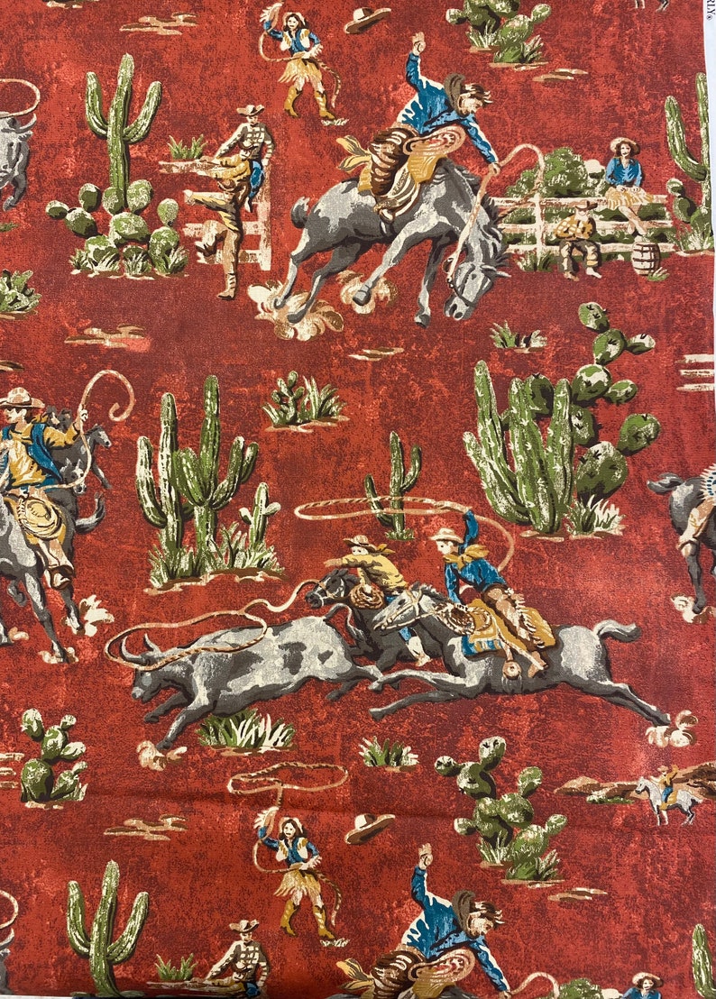 May include: A red fabric with a repeating pattern of cowboys riding horses and bulls, cacti, and lasso ropes. The cowboys are wearing blue, brown, and white clothing. The fabric has a vintage look.
