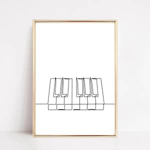 May include: A black and white line drawing of a piano keyboard in a gold frame.