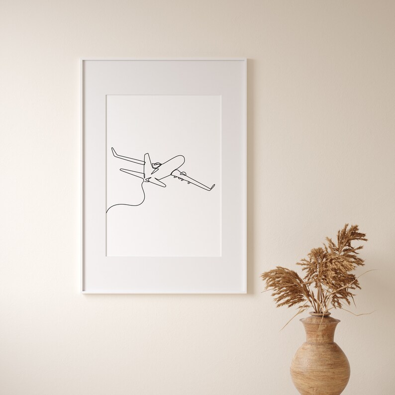 May include: A black and white line drawing of an airplane in flight, framed in a white frame.