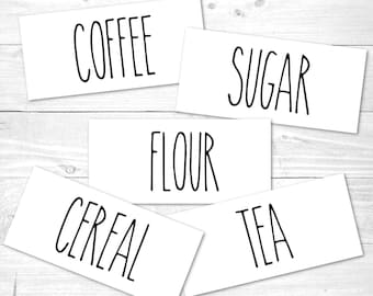 May include: Five white labels with black text, each with a different word: Coffee, Sugar, Flour, Cereal, Tea.