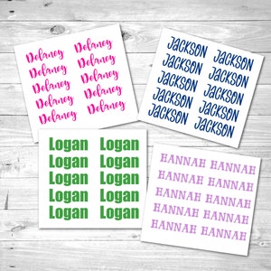 May include: Eight sheets of white sticker paper with rows of names printed in different colors. The names are Delaney, Jackson, Logan, and Hannah.