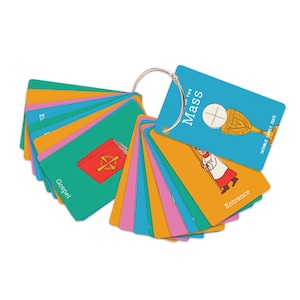 May include: A set of colorful flashcards attached to a silver ring. Each card features a different illustration and text, including a chalice, a book, and a person in a white robe. The cards are labeled with words like "Gospel" and "Entrance".