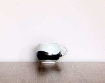 Handmade ceramic coffee/tea cup in black and transparent glaze