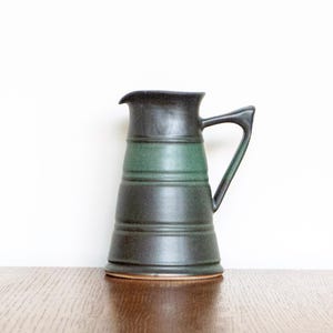 Handmade stoneware ceramic pitcher in matte emerald green/black