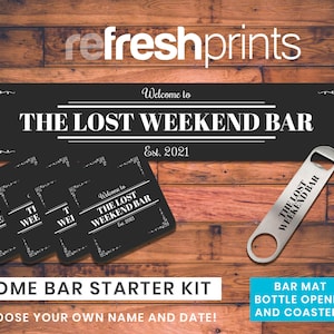 May include: A home bar starter kit with a black sign reading "THE LOST WEEKEND BAR", coasters, and a bottle opener. The sign and coasters have decorative borders and the text "Est. 2021". The kit includes a bar mat, bottle opener, and coasters.