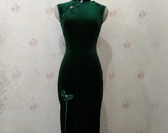 May include: A dark green velvet cheongsam dress with a mandarin collar and floral embellishments.