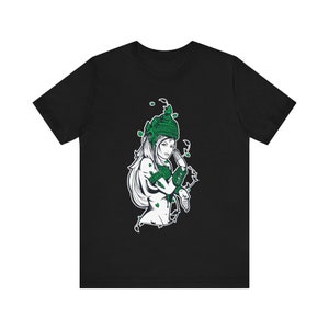 May include: Black t-shirt with a white graphic of a woman with green leaves and a crown on her head.