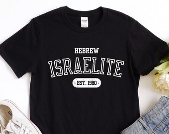 May include: Black t-shirt with white text that reads "HEBREW ISREALITE EST. 1980".