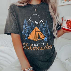 Może przedstawiać: Szary t-shirt z nadrukiem namiotu w lesie z ogniskiem i tekstem "Feast of Tabernacles".