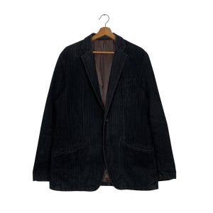 May include: A black corduroy blazer with a single button closure and two front pockets.