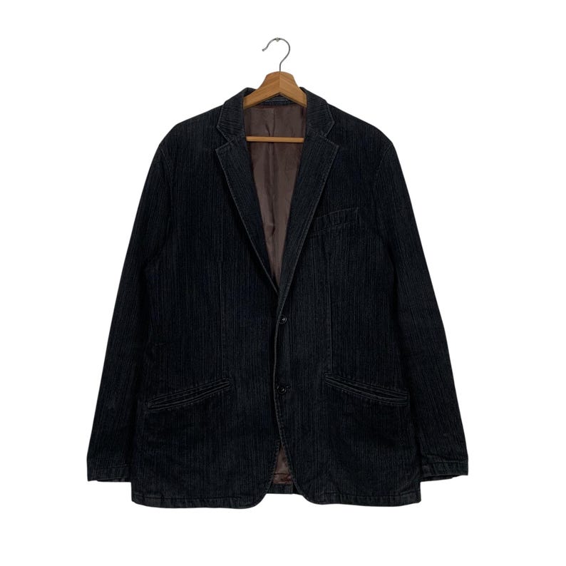 May include: A black corduroy blazer with a single button closure and two front pockets.