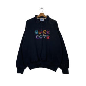 May include: Black sweatshirt with a colorful embroidered logo that says "Black Comb" on the front.